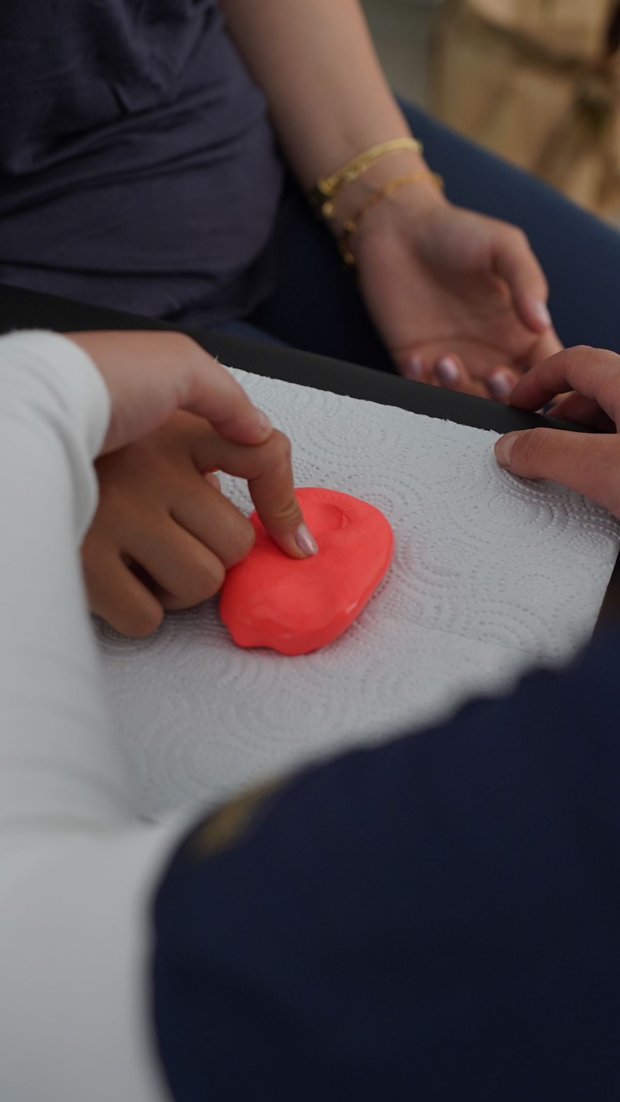 A child strengthening their hands with therapy putty during occupational therapy